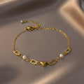 SVORA gold-plated stainless steel bracelet with heart, pearl, and rectangle links. Adjustable.
