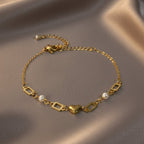 SVORA gold-plated stainless steel bracelet with heart, pearl, and rectangle links. Adjustable.