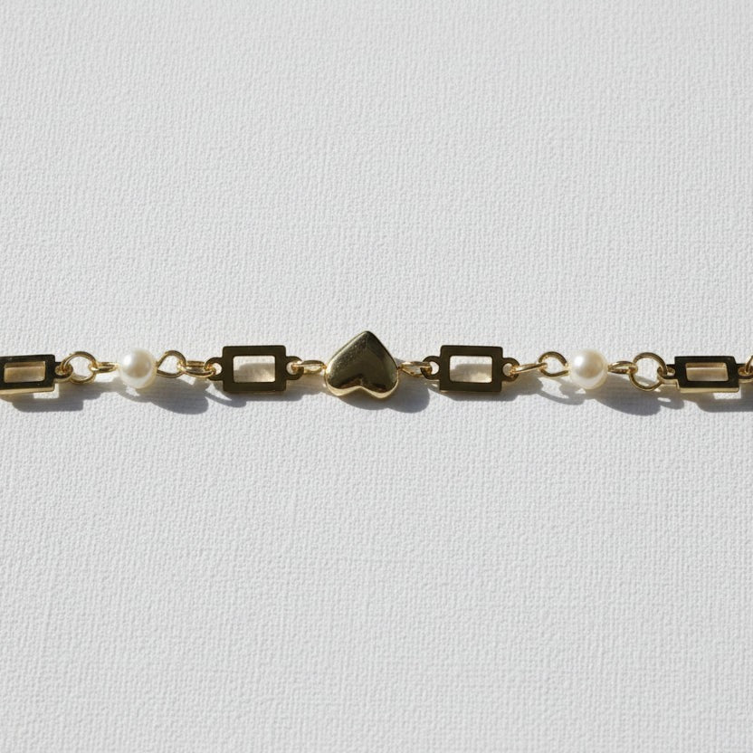 SVORA gold plated stainless steel bracelet with heart, pearl, and rectangle links. Adjustable.