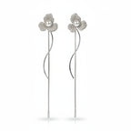 SVORA silver-tone stud earrings with three pavé-set petals and a central pearl, featuring a delicate chain drop.