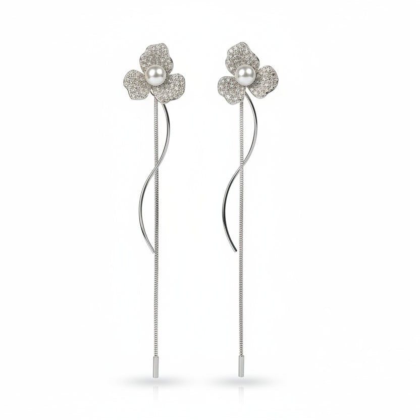SVORA silver-tone stud earrings with three pavé-set petals and a central pearl, featuring a delicate chain drop.