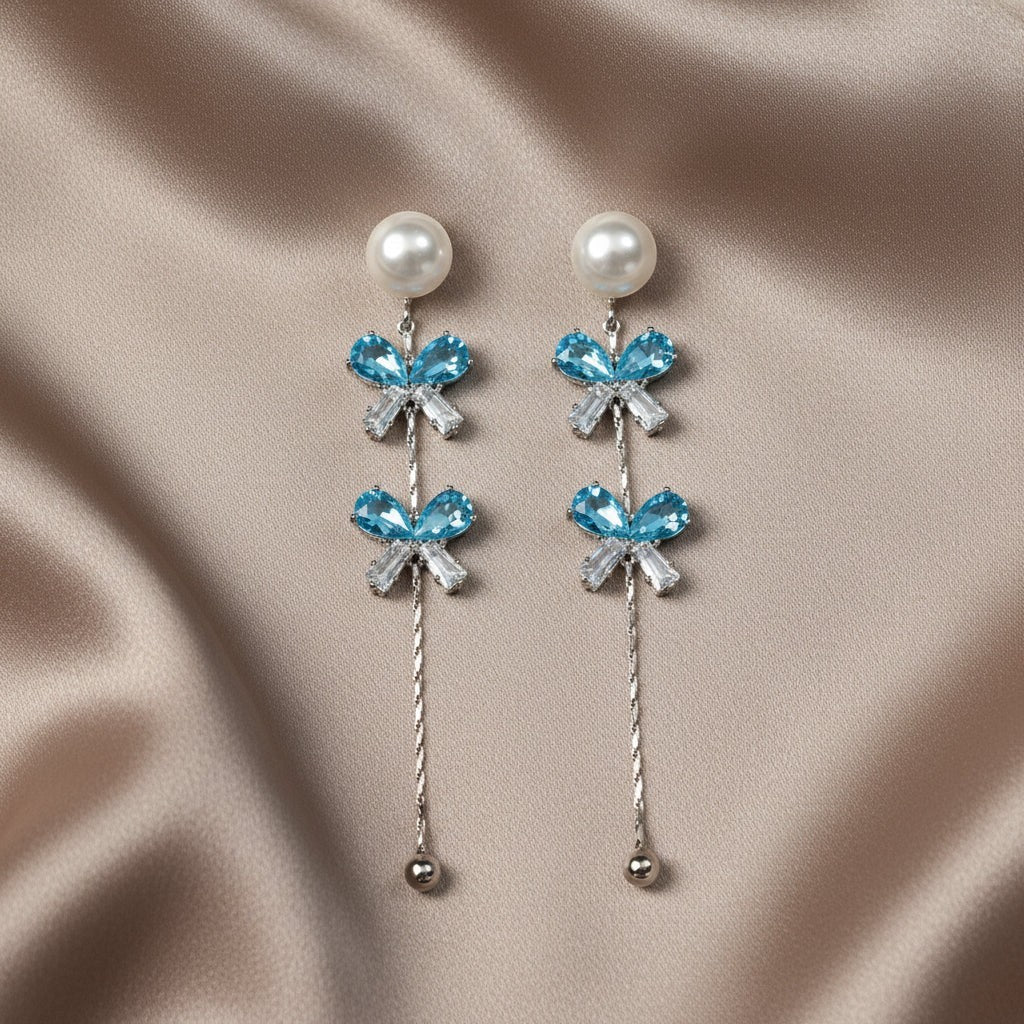 SVORA pearl stud aqua drop dangler earrings with blue crystal clusters and baguette cubic zirconia.