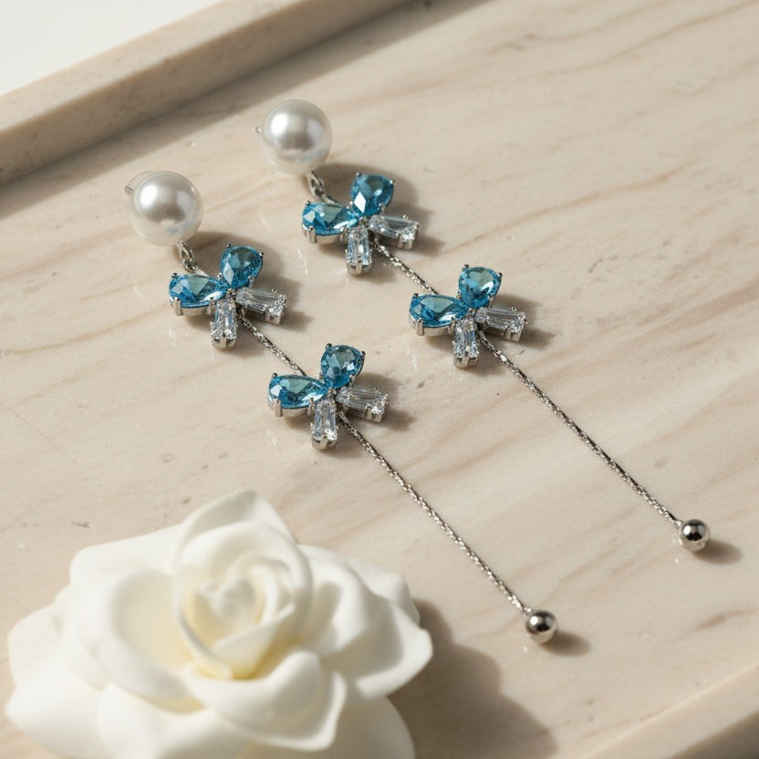 SVORA pearl stud aqua drop dangler earrings with blue crystal clusters and baguette cubic zirconia.