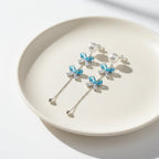 SVORA pearl stud aqua drop dangler earrings with blue crystal clusters and baguette cubic zirconia.