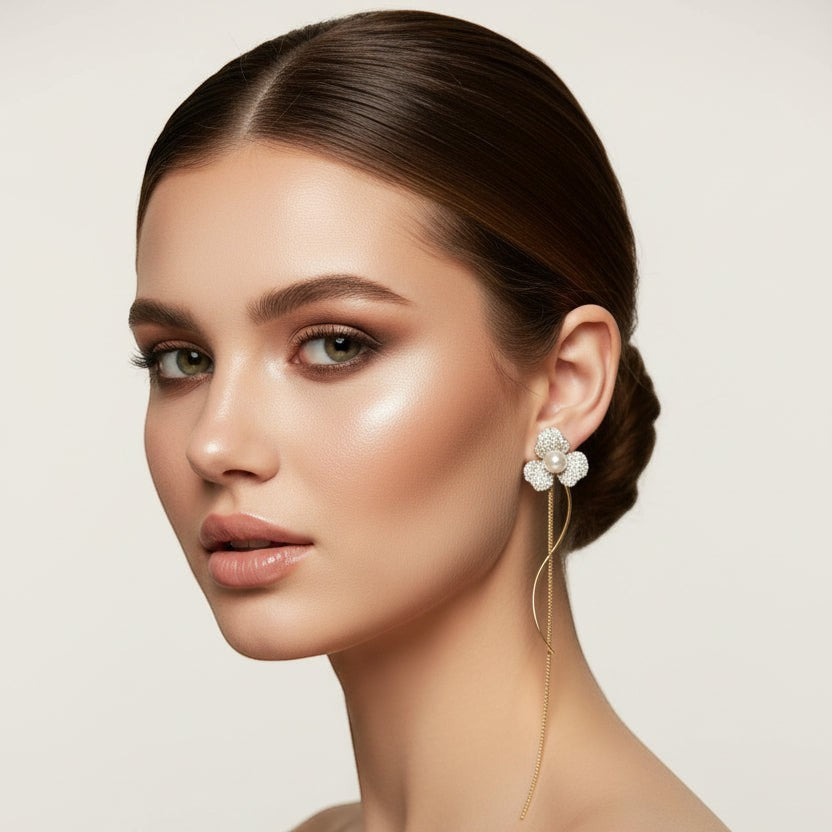 SVORA silver-tone stud earrings with three pavé-set petals and a central pearl, featuring a long, delicate chain.