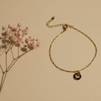 SVORA petite gold plated stainless steel bracelet with circle drop charm and lobster clasp.