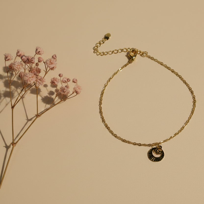 SVORA petite gold plated stainless steel bracelet with circle drop charm and lobster clasp.