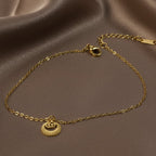 SVORA Petite Circle Drop Chain Bracelet in gold-plated stainless steel with lobster clasp. Minimalist design.