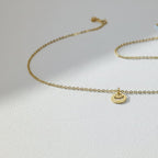 SVORA Petite Circle Drop Chain Bracelet in gold-plated stainless steel with a sunburst charm.