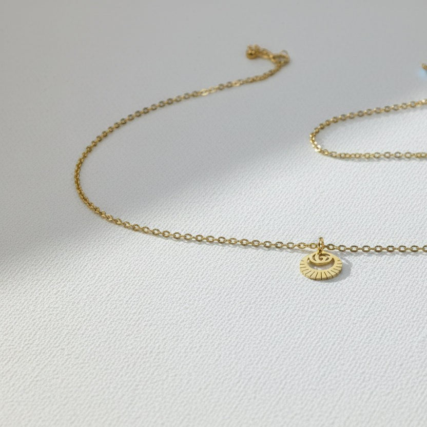 SVORA Petite Circle Drop Chain Bracelet in gold-plated stainless steel with a sunburst charm.