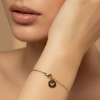 SVORA petite gold chain bracelet with a single etched-edge circle charm, adjustable lobster clasp.