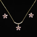 SVORA pink crystal flower necklace and stud earrings set with pearl accents on gold chain.