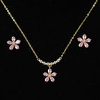 SVORA pink crystal flower necklace and stud earrings set with pearl accents on gold chain.