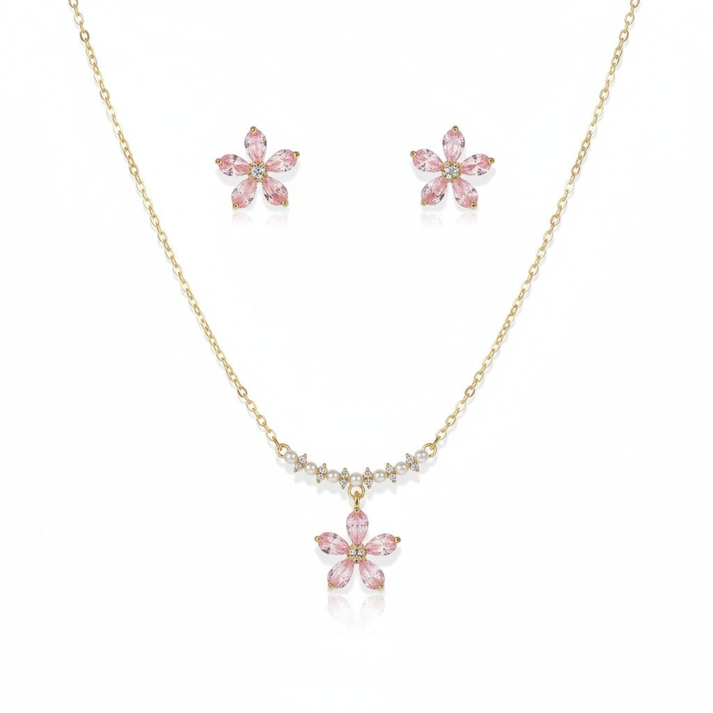 SVORA pink crystal flower necklace and stud earrings set with pearl and CZ accents on gold chain.