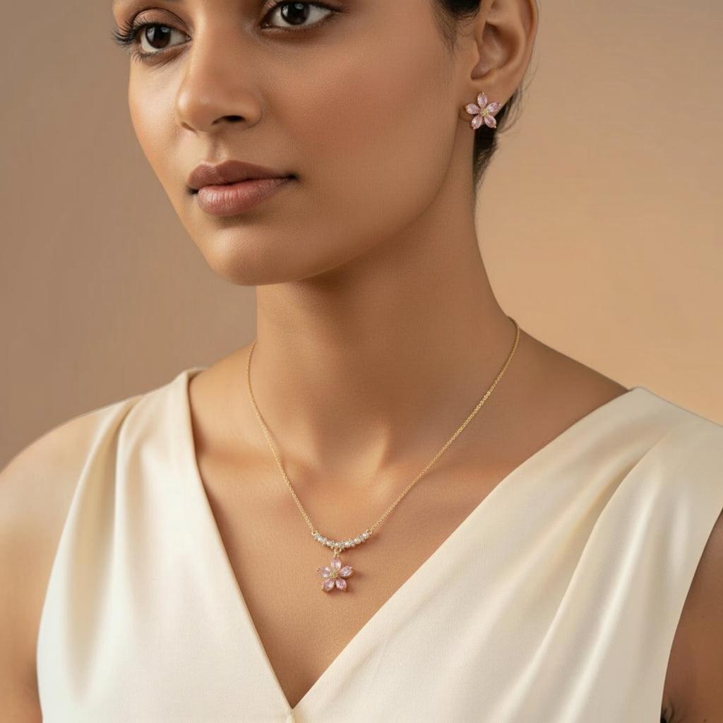 SVORA gold-tone necklace and earrings set with pink crystal flower pendants and pearl accents.