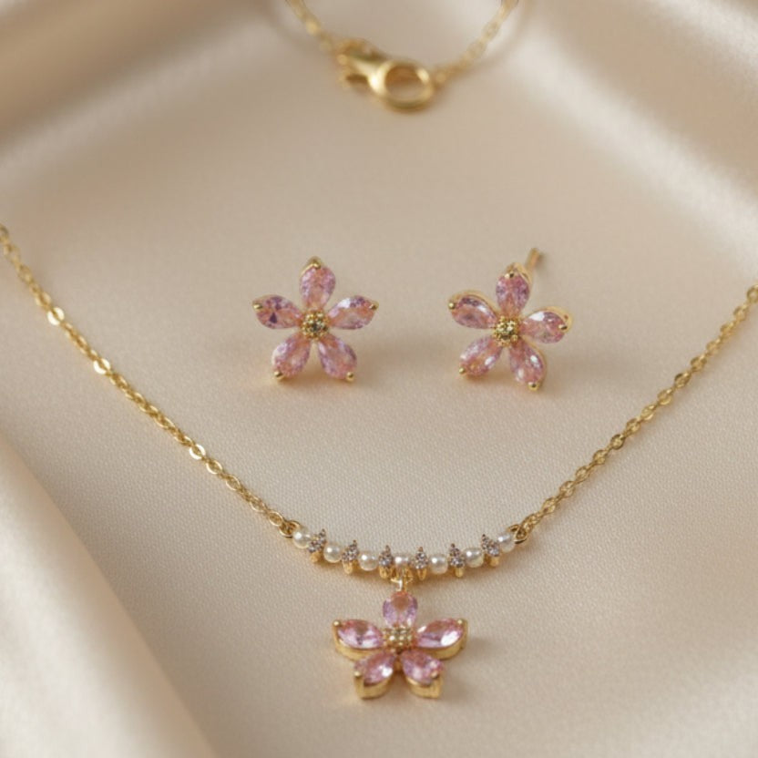 SVORA pink crystal flower necklace and stud earrings set with pearl accents on a gold-tone chain.
