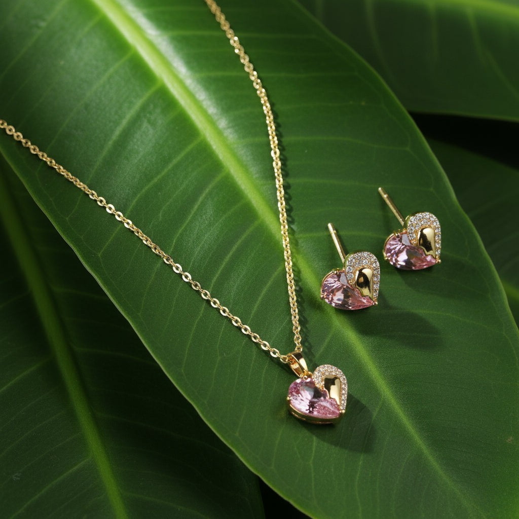 SVORA gold tone necklace and earrings set with pink heart-shaped crystals and cubic zirconia accents.
