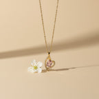 SVORA gold plated stainless steel necklace with a pink heart-shaped sapphire pendant surrounded by small clear crystals.