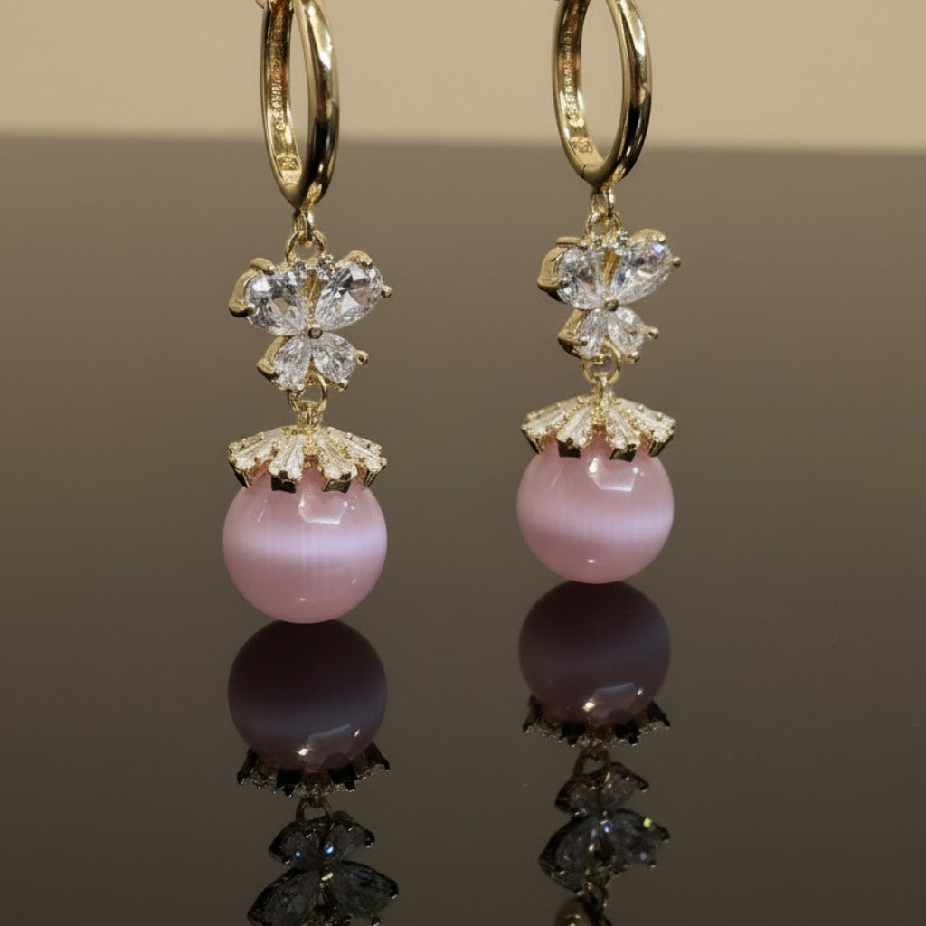 SVORA pink pearl butterfly dangler earrings with gold hoops and crystal accents.
