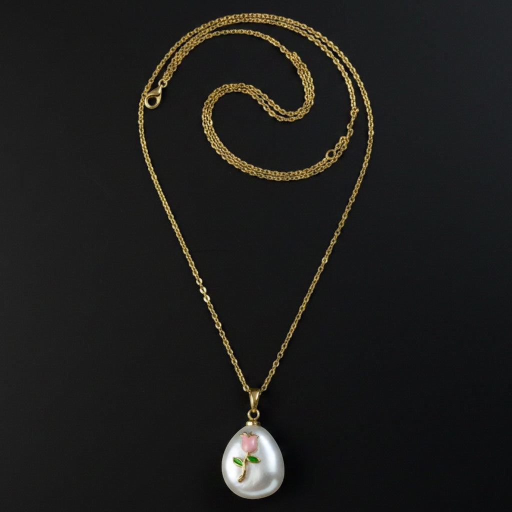 SVORA pink rose and pearl pendant necklace with gold chain. Features a white baroque pearl with a pink rose and green leaves design.
