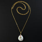 SVORA pink rose and pearl pendant necklace with gold chain. Features a white baroque pearl with a pink rose and green leaves design.