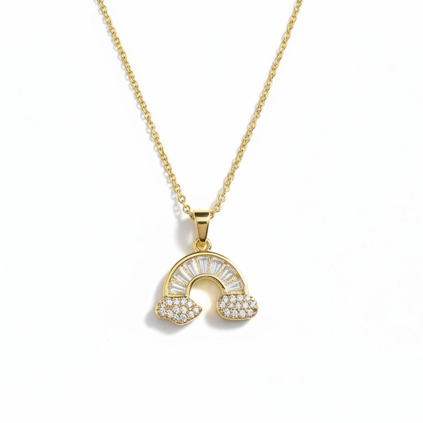 SVORA gold plated stainless steel necklace with a rainbow pendant adorned with baguette and pave crystals.