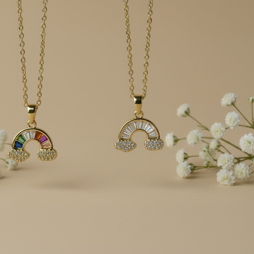 SVORA gold plated stainless steel rainbow necklace with cubic zirconia clouds. One necklace features colorful rainbow stones, the other clear stones.