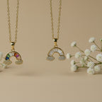 SVORA gold plated stainless steel rainbow necklace with colorful stones and cloud details.