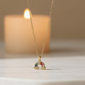 SVORA gold plated stainless steel rainbow necklace with colorful stones and cloud details.