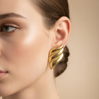 SVORA gold ribbed dome sculptural stud earrings with deep ridge work and high polish.