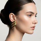 SVORA gold ribbed dome sculptural stud earrings with high polish finish.