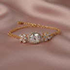 SVORA rose gold layered bracelet with oval white CZ center and flower accents. Adjustable.