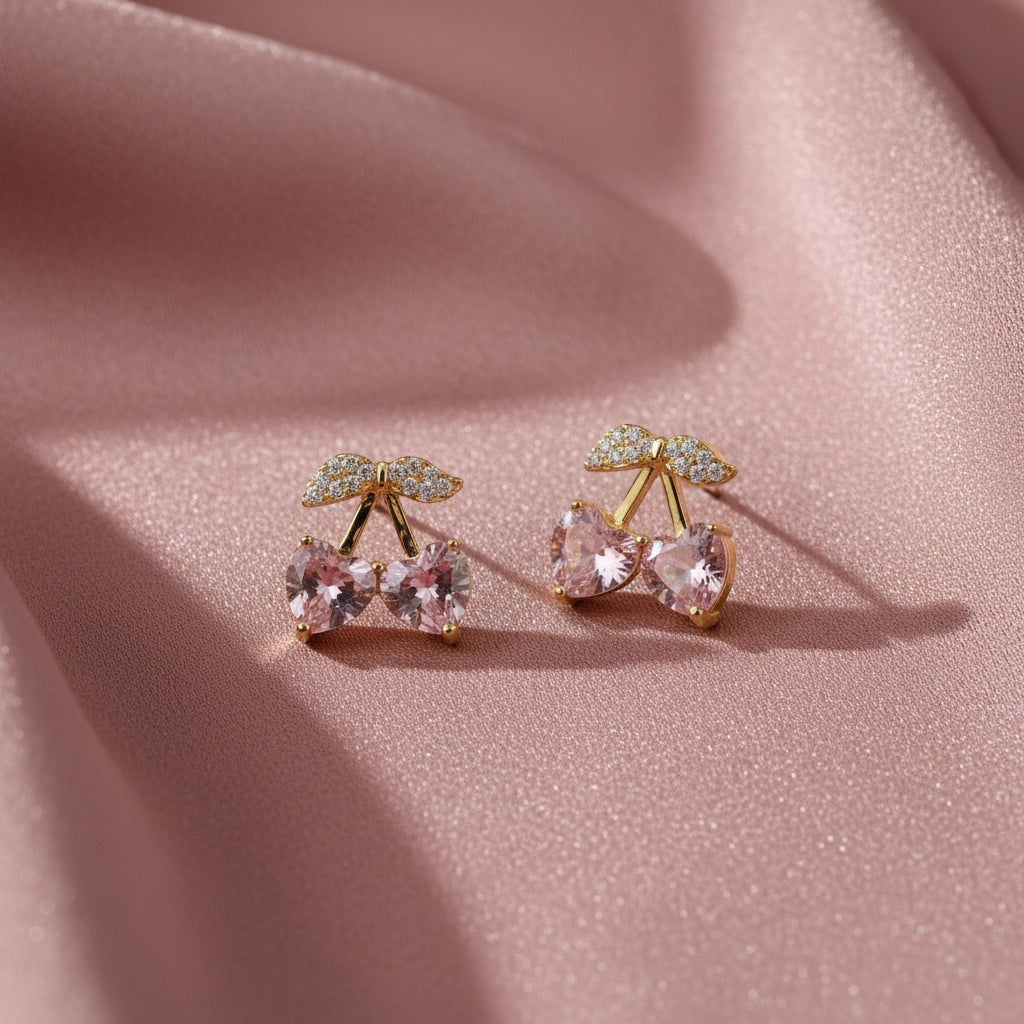 SVORA gold tone stud earrings with pink heart-shaped crystals and clear crystal accents, resembling cherries.