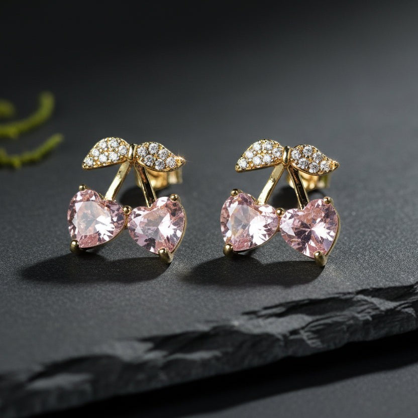 SVORA gold tone stud earrings with pink heart crystals and small leaf detail with clear cubic zirconia.