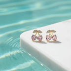 SVORA gold tone stud earrings with pink heart crystals and clear crystal accents, shaped like cherries.