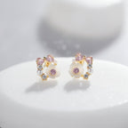 SVORA Rose Pearl Bow Stud Earrings with pink crystals, pearls, and cubic zirconia on a gold-tone setting.