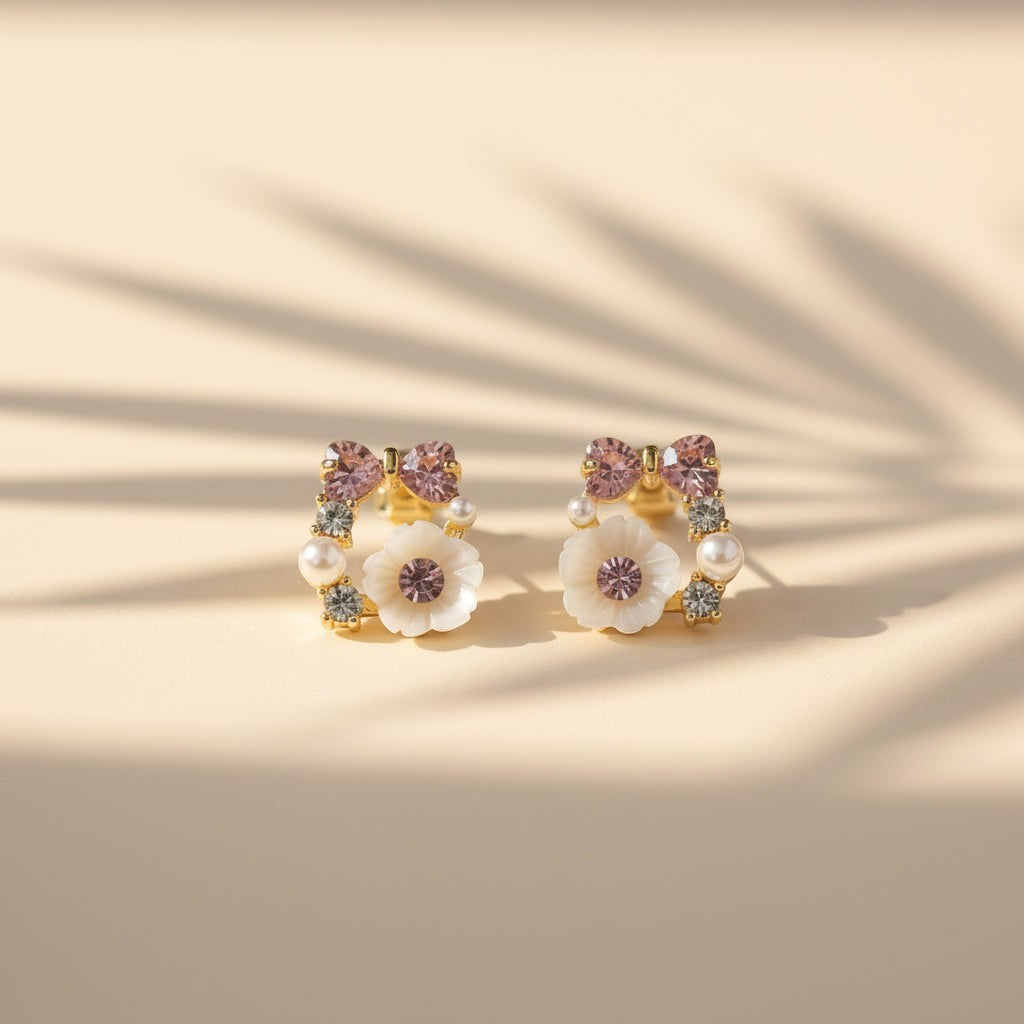 SVORA rose pearl bow stud earrings with pink crystals, mother-of-pearl florets, and cubic zirconia accents.