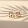 SVORA rose pearl bow stud earrings with pink crystals, mother-of-pearl florets, and cubic zirconia accents.