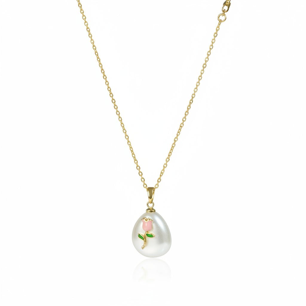 SVORA gold chain necklace with a white baroque pearl pendant featuring a pink rose and green leaves design.