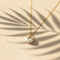 SVORA gold chain necklace with a baroque pearl pendant featuring a pink rose and green leaves design.