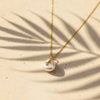SVORA gold chain necklace with a baroque pearl pendant featuring a pink rose and green leaves design.