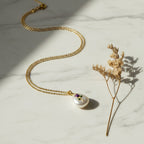 SVORA amethyst-purple enamel rose pendant with gold stem on a baroque pearl, on a fine gold chain.