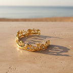 SVORA gold plated stainless steel Seascape cuff bracelet with palm trees, shells, and turtles.
