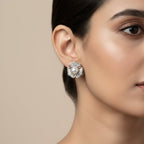 SVORA silver-tone flower stud earrings with baguette cubic zirconia petals and a pearl center.