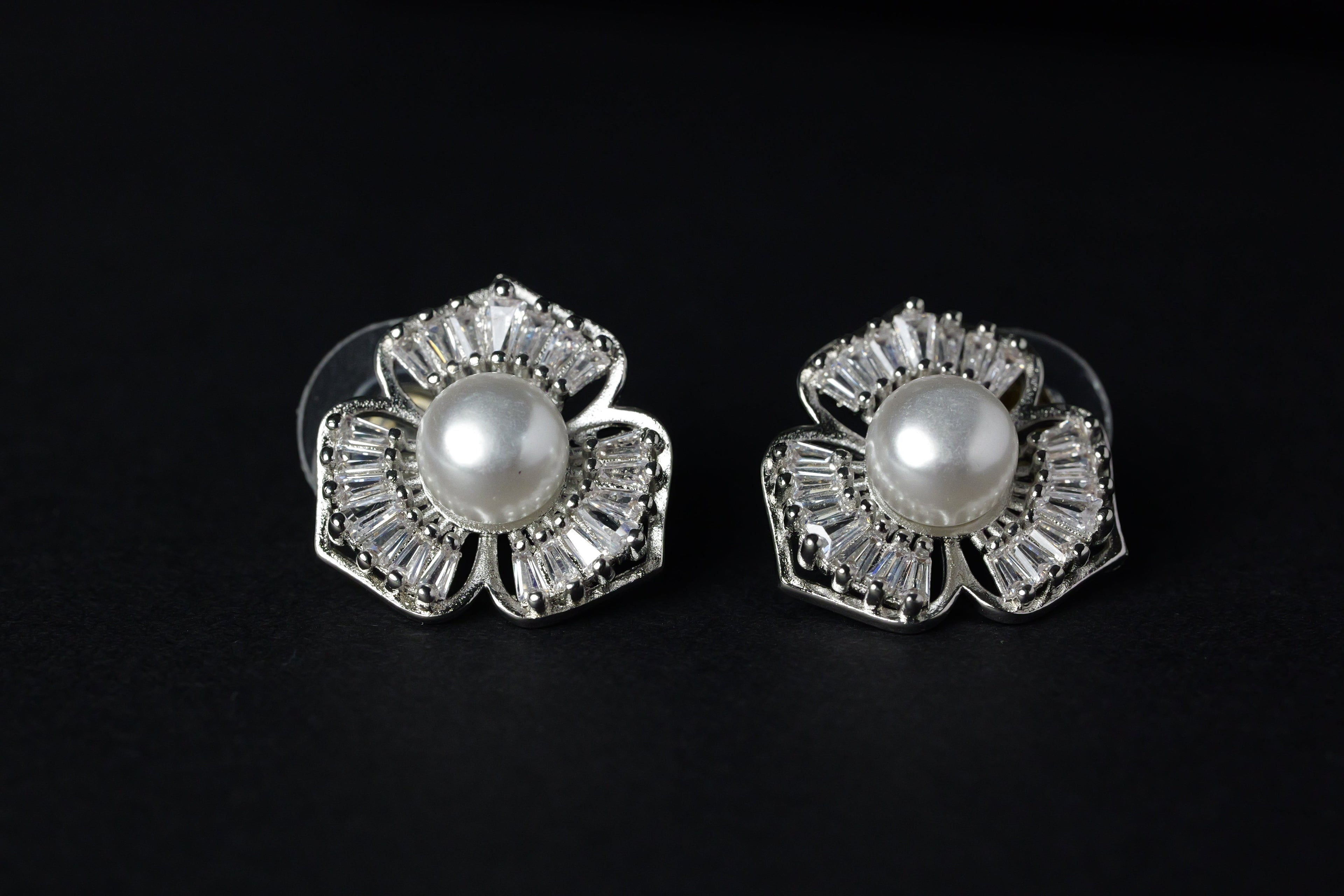 SVORA Silver petal pearl stud earrings with baguette cubic zirconia petals and a freshwater pearl center.
