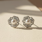 SVORA silver-tone flower stud earrings with baguette cubic zirconia petals and a pearl center.