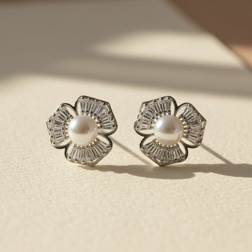 SVORA silver-tone flower stud earrings with baguette cubic zirconia petals and a pearl center.