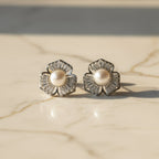 SVORA silver-tone stud earrings with five petal flower design, baguette cubic zirconia petals, and a pearl center.