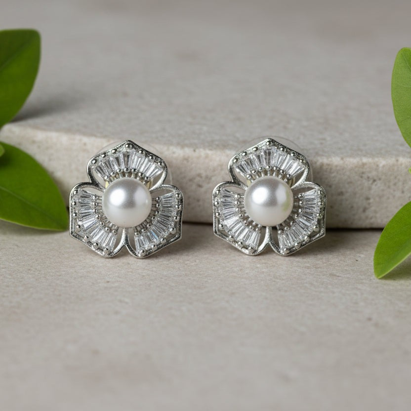 SVORA silver-tone flower stud earrings with baguette cubic zirconia petals and a pearl center.