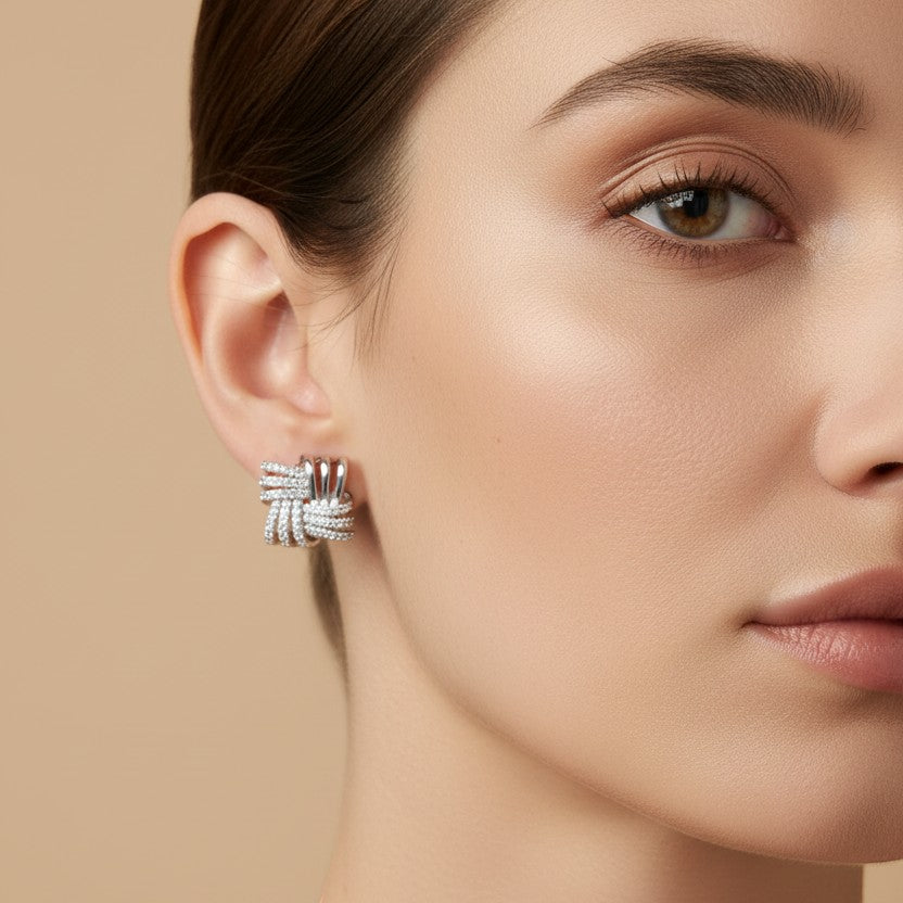 SVORA silver square knot stud earrings with cubic zirconia stones, made of stainless steel with rhodium plating.